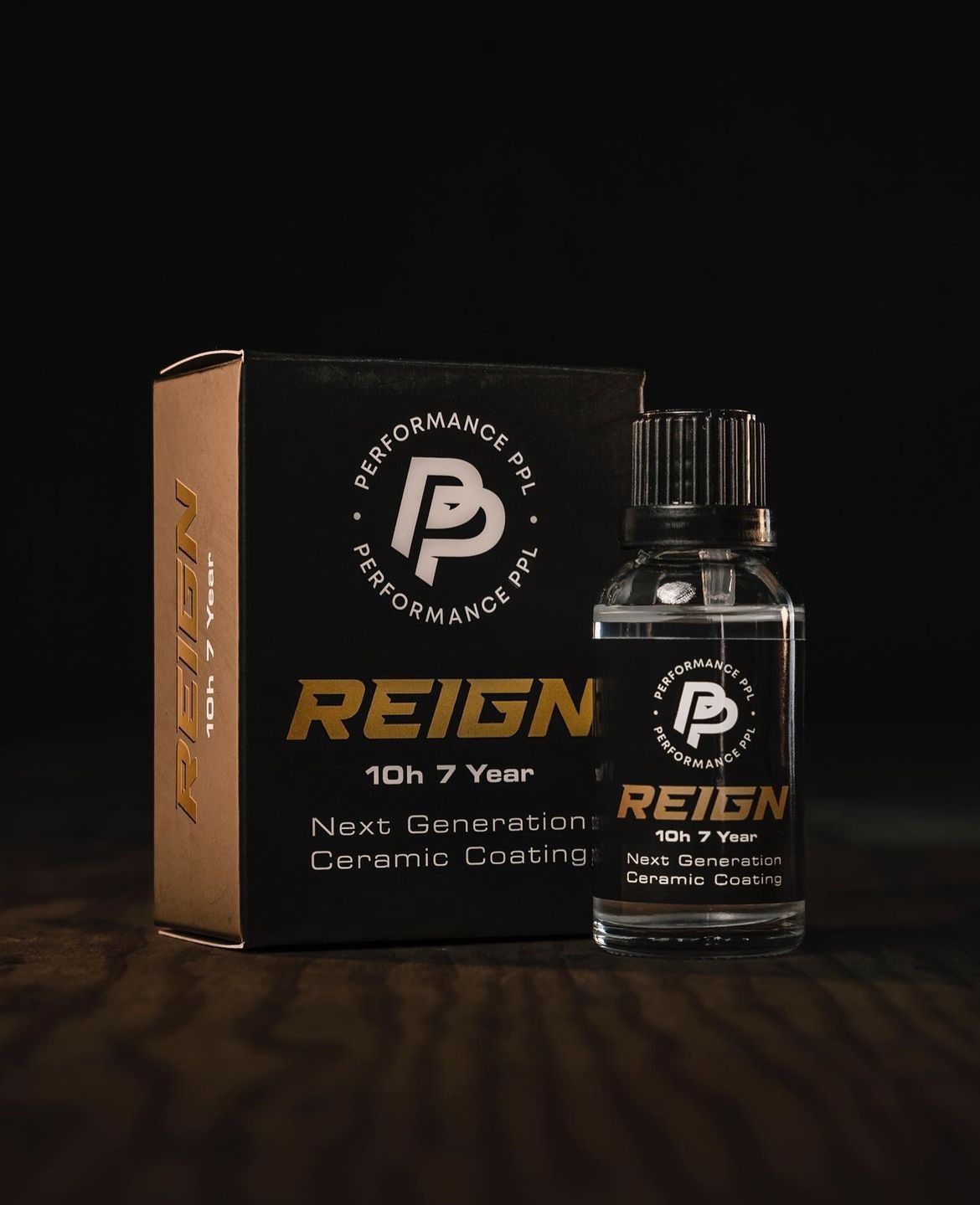 Reign 10h 7 year ceramic coating bottle and box, black background.